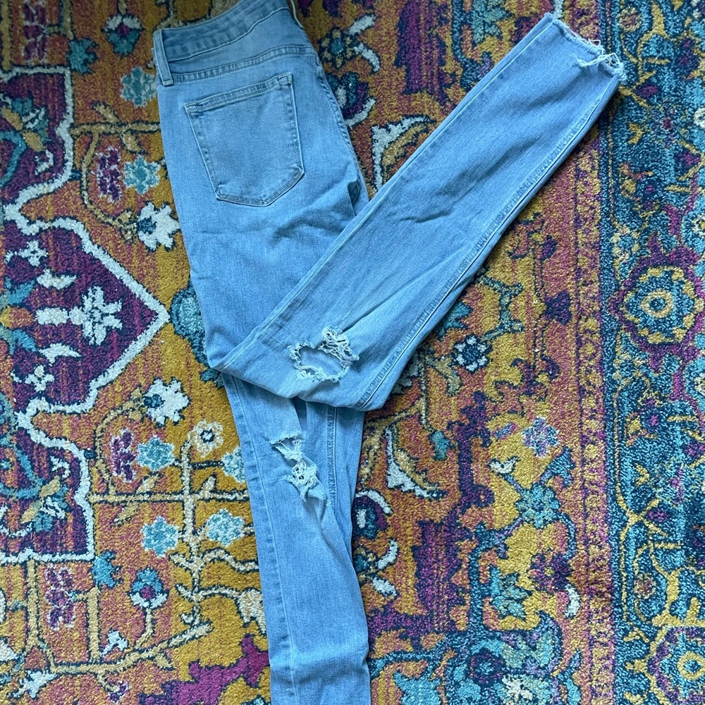 Just Black skinny jeans with distressing throughout in a size 27.